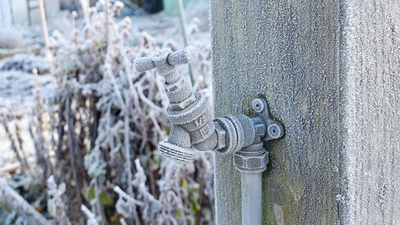 A tap which has frozen over in the winter weather.