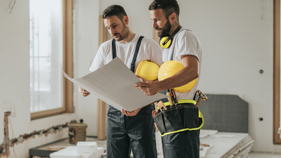 Two builders looking at a plan