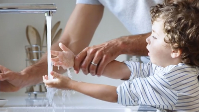 Father and son washing hands