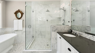 Beautiful master bathroom with shower, bathtub, and sink, with high end furnishings, lights on