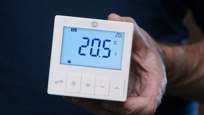 JG Underfloor Heating Controls thermostat in hand